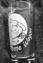 Load image into Gallery viewer, 16oz pint glass with image of Isabelle from Animal Crossing in a circle. She is smiling and her arms are open to give you a hug. Around the circle are the words "New Leaf Welcome Wagon".
