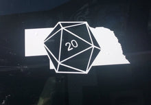 Load image into Gallery viewer, White car decal on the state of Nebraska with a D20 die superimposed at an angle. 
