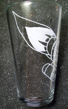 Load image into Gallery viewer, A pint glass etched with the Serentiy ship from Firefly. The ship is angled downward and wraps around the glass. This photo shows the back end of the ship.