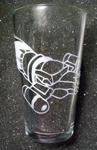 Load image into Gallery viewer, A pint glass etched with the Serentiy ship from Firefly. The ship is angled downward and wraps around the glass. This photo si the middle of the ship