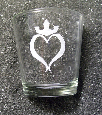 An extra extra large shot glass etched with an open heart. There is a crown above the heart. 