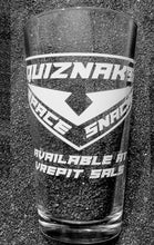 Load image into Gallery viewer, A pint glass etched with a large triangle. Inside the triangle is the Voltron logo and the words "Quiznak's Space Snacks". Underneath the triagnle it reads "available at Vrepit Sals.