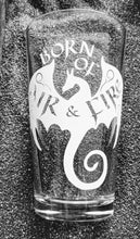 Load image into Gallery viewer, A pint glass featuring an etched dragon design. The dragon is flying, wings outspread and tail curled. The words "Born of" are above the dragon's head. The words "Air & Fire" are written on the dragon's wings, along with small curliques.