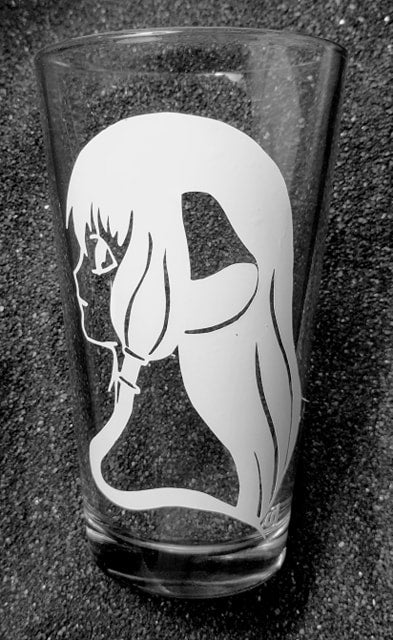 A Chobits pint glass etched with Chii's profile. You see her trademark ears and hairsyle. 