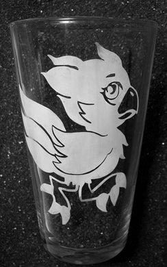 A pint glass featuring an etched chocobo design. The chocobo is cute and fat instead of leggy like an adult. It is running, with its wings at its sides. 