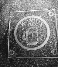 Load image into Gallery viewer, A clear square glass coaster etched with a circle frame. Inside the frame is an overflowing beer tankard. Above the tankard are the words &quot;McAnally&#39;s Pub&quot;. 
