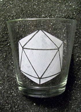An extra extra large shot glass with a 20-sided die etched on it. 