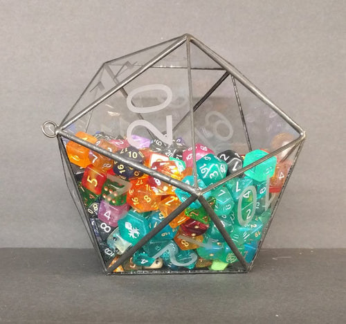 A glass and metal D20 die, half-full with multi-colored dice. There are 222 dice in the terrarium. 