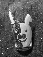 Load image into Gallery viewer, An etched pint glass with Monami&#39;s rabbit face on it. The left half is white with the ear folded down. The right half is clear with an upright ear and a bow at the ear&#39;s base. 
