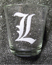 Load image into Gallery viewer, A shot glass etched with a capital L in Old English Font. 
