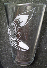 Load image into Gallery viewer, A pint glass etched with the Serentiy ship from Firefly. The ship is angled downward and wraps around the glass. This photo shows how much the design wraps around. Yo ucan see the nose of the ship in the foreground and the back of the ship through the other side of the glass.  
