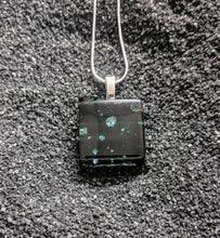 Load image into Gallery viewer, A square pendant made of glass. The design is black glass with small clusters of glitter sprinkled throughout. 
