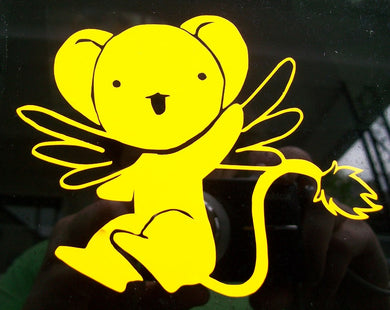 Kero decal made of bright yellow vinyl. He is in his small teddybear form, sitting with his wings outstretched and his left hand waving hello. His mouth is open and you can see his tail. 