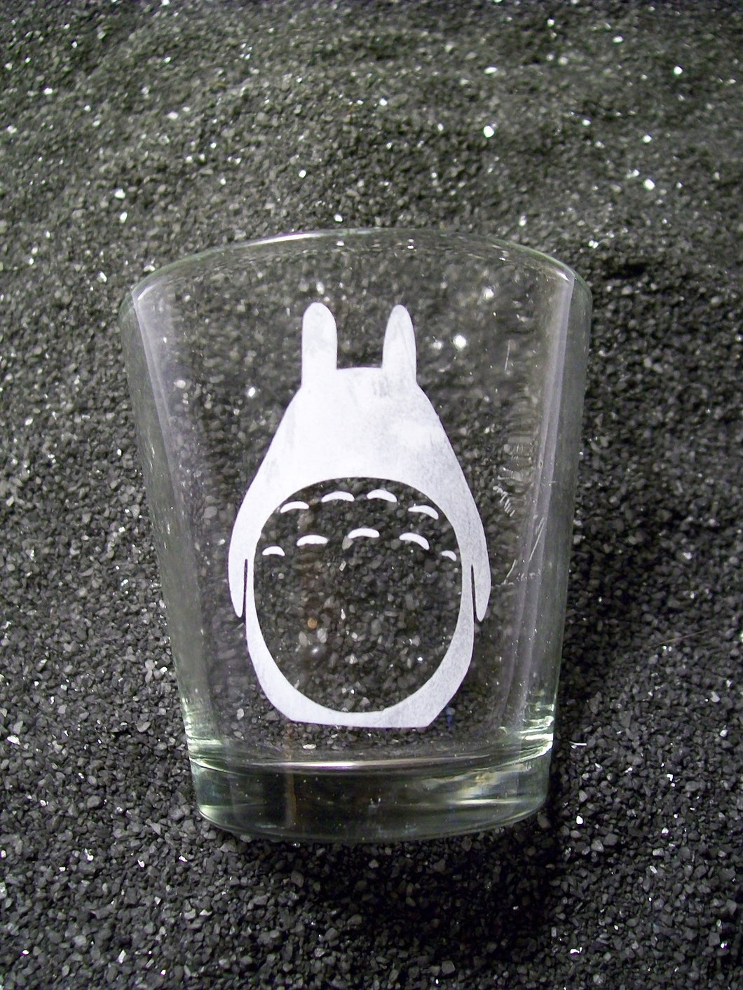 An extra extra large shot glass etched with a stylized Totoro. 